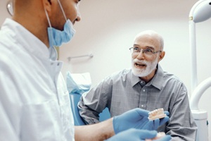 man at implant denture consultation with his implant dentist in Pam Bay