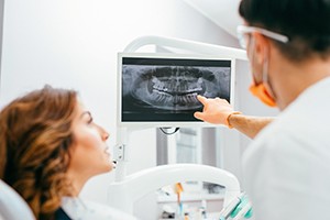 Patient and dentist looking at x-rays