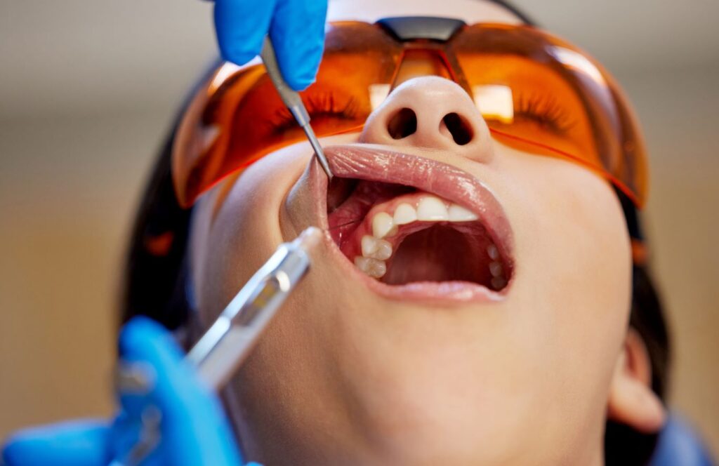 A woman having her tooth examined by a dentist