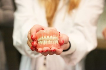 person holding dentures