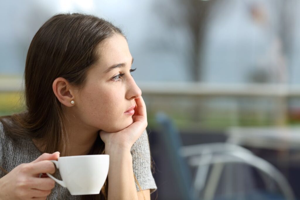 A woman holding a cup of coffee